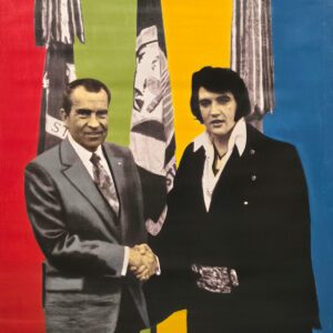 Two men shaking hands before colorful striped backdrop