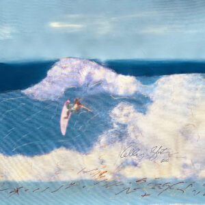 Surfer on pink surfboard riding large wave